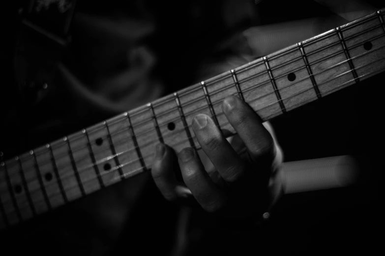 a person with an electric guitar in their hands