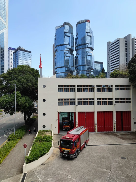 two trucks parked in a parking lot in front of a large building