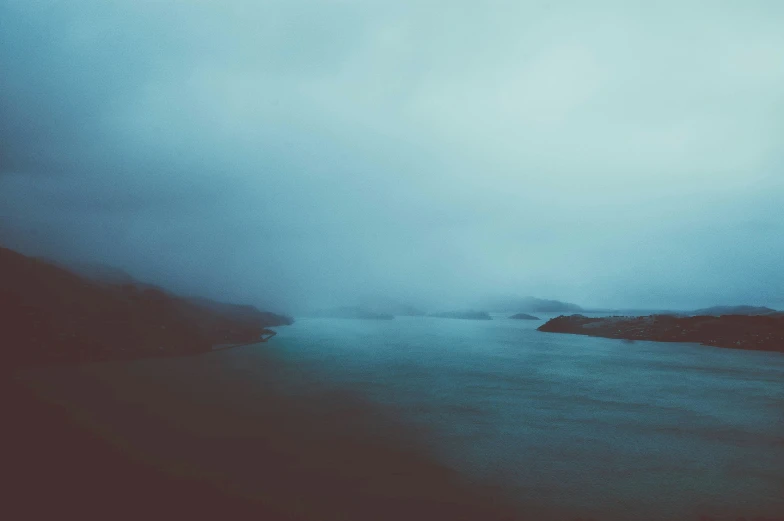 an abstract landscape of a lake surrounded by mountains