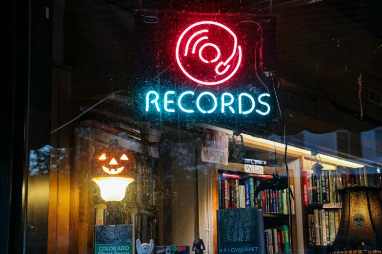 the record shop with a large neon sign above it