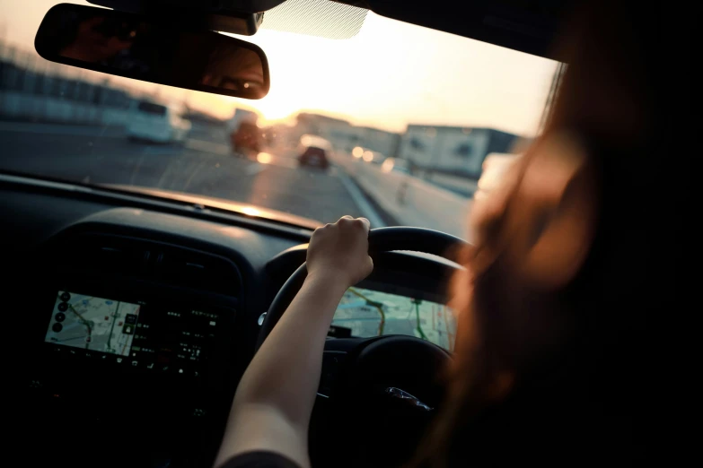 the view from inside of a car looking at sunset