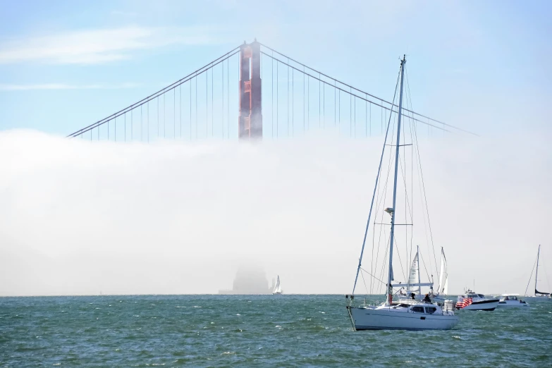 a boat is sailing next to a golden gate bridge