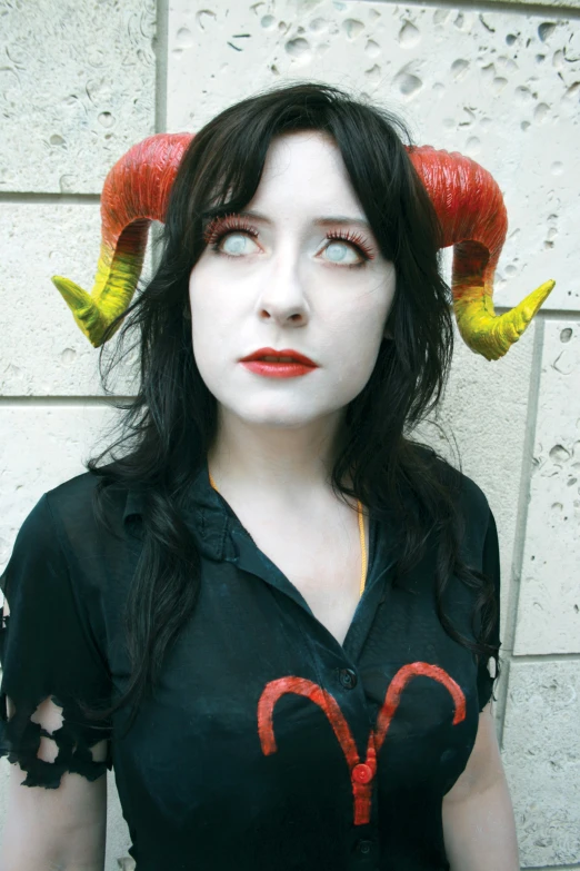 there is a woman wearing horns and makeup