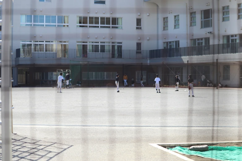 several people playing with balls while others watch