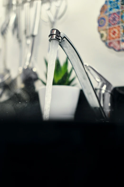 a white bowl of water sitting next to a sink