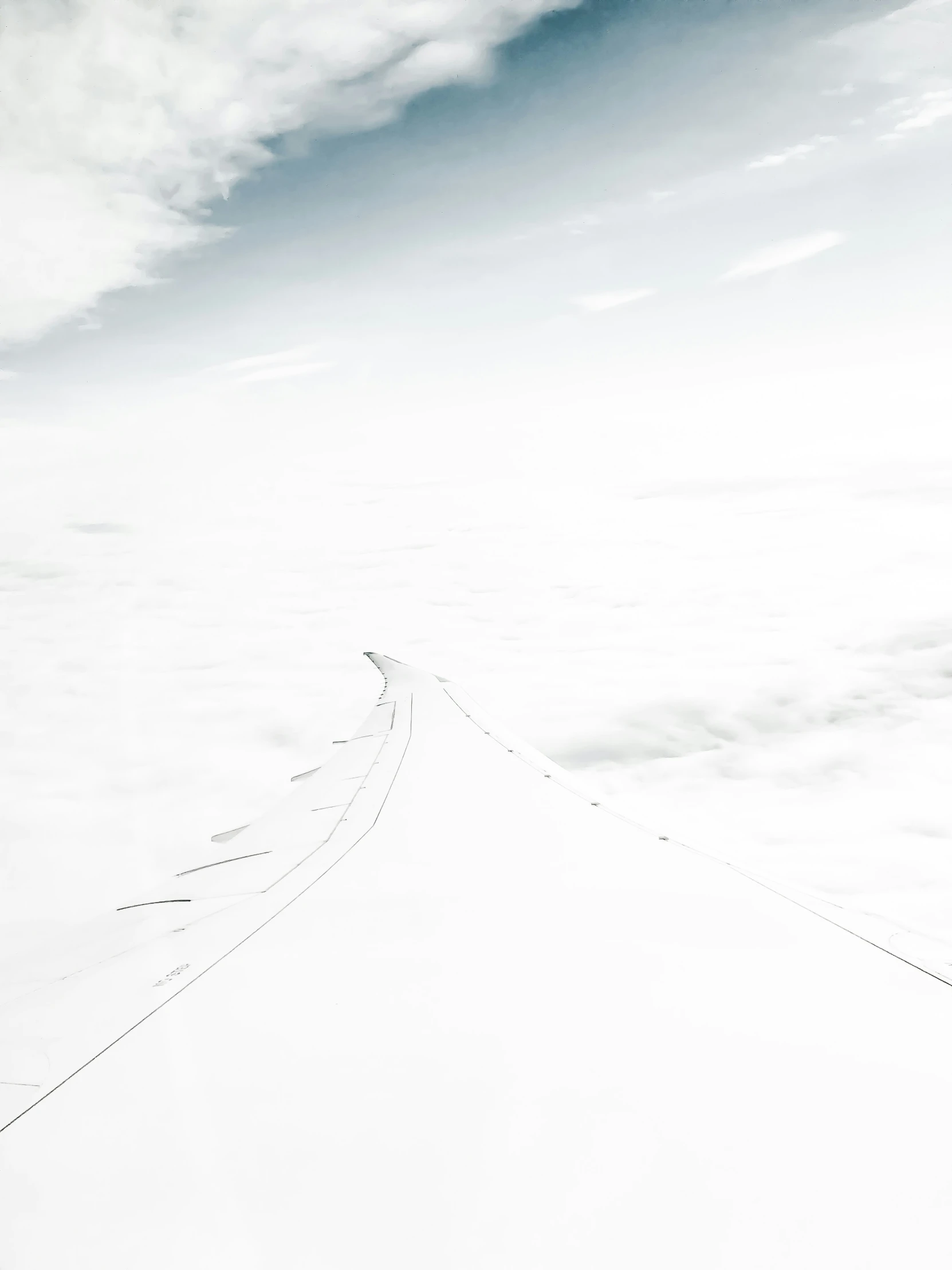 clouds below the sky and above a street sign