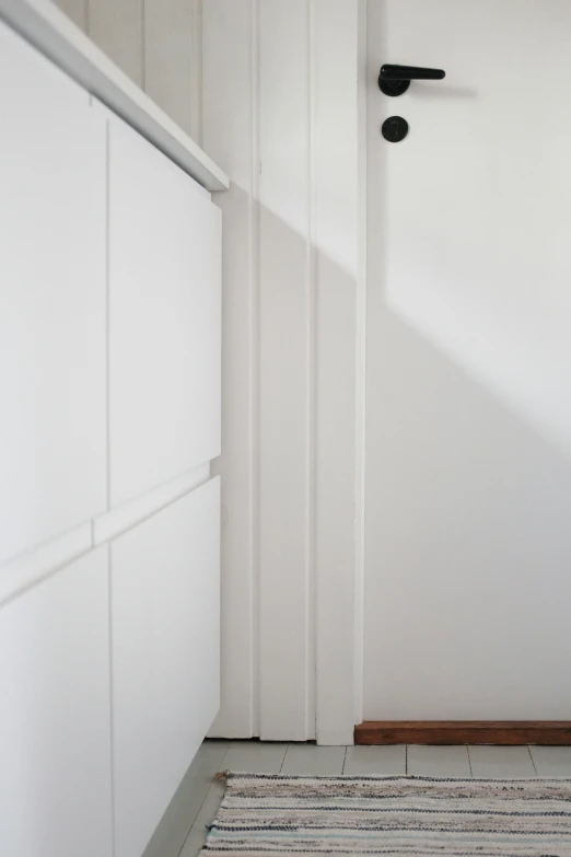 an empty and clean hallway with two white doors