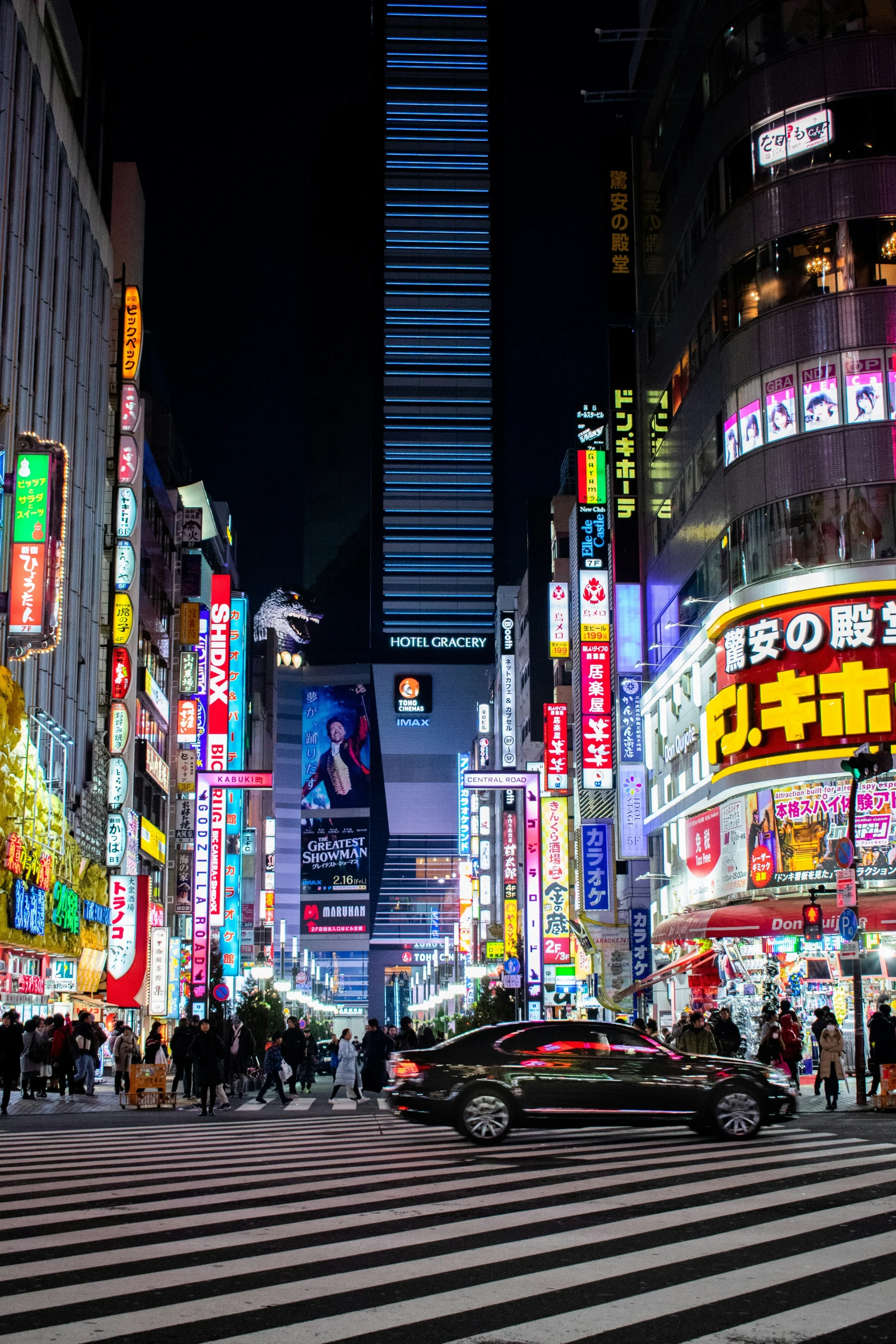 a group of people on a busy street at night