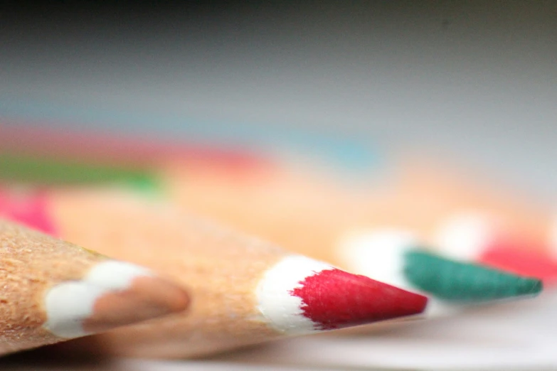 a row of colored pencils that are facing one another