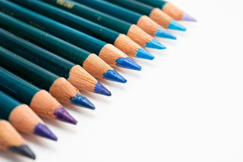 a group of blue pencils in a row