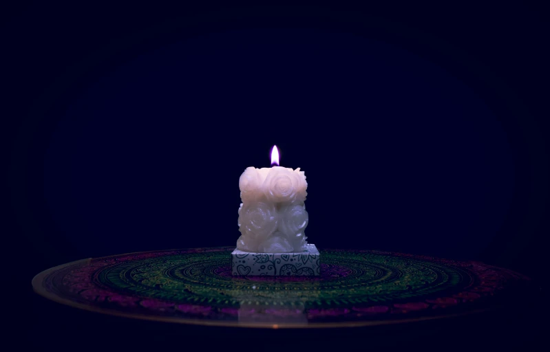 a candle burning and placed on a surface