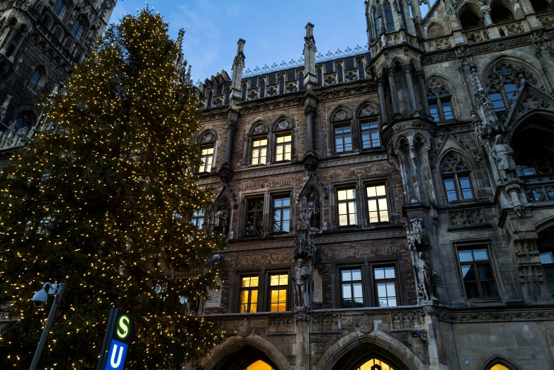 an old building with lots of windows covered in christmas lights