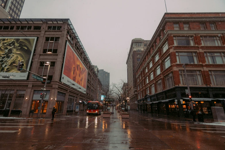 city street in the middle of a rainy day with traffic stopped at a traffic signal