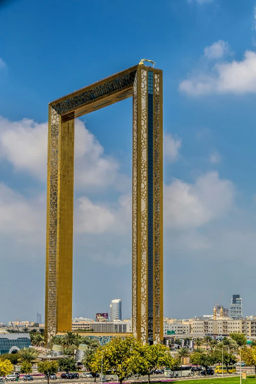 a giant clock tower surrounded by trees in the city