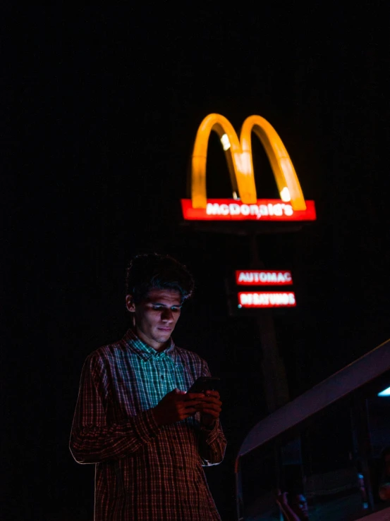 a man standing at a mcdonalds in front of the mcdonalds