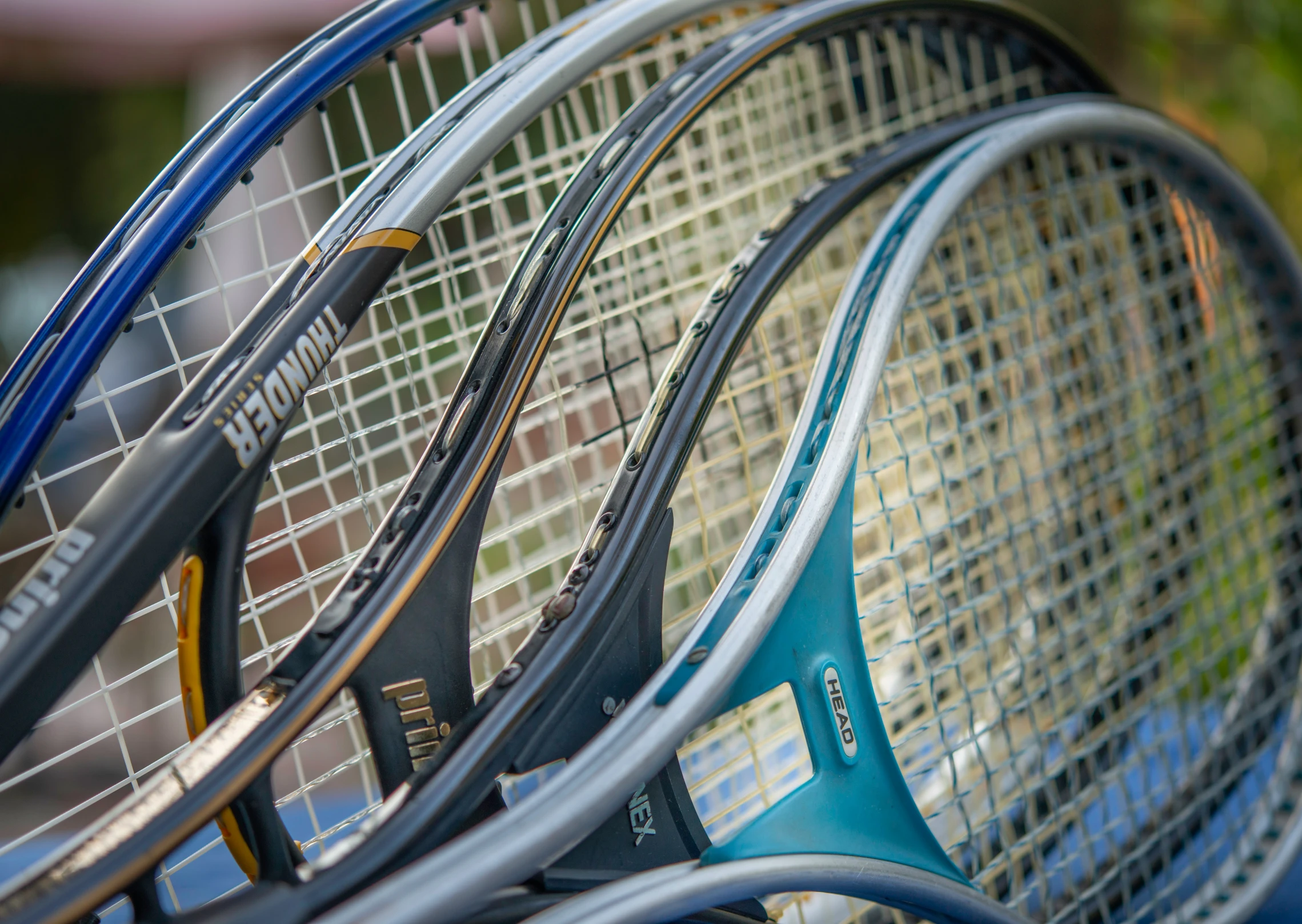 tennis racquets laying side by side on a racket