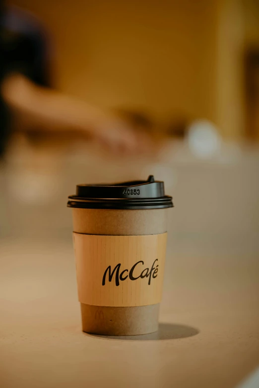 a cup on top of a counter that has mocaffe written on it