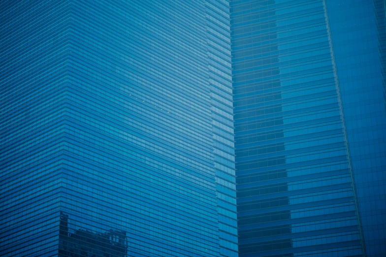 an airplane flying through the sky behind a tall building