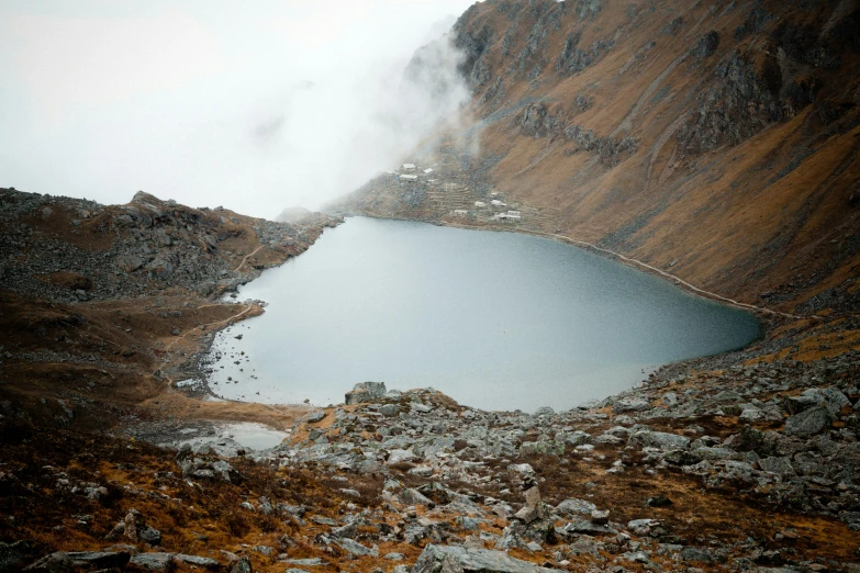 a large blue lake surrounded by brown rocks