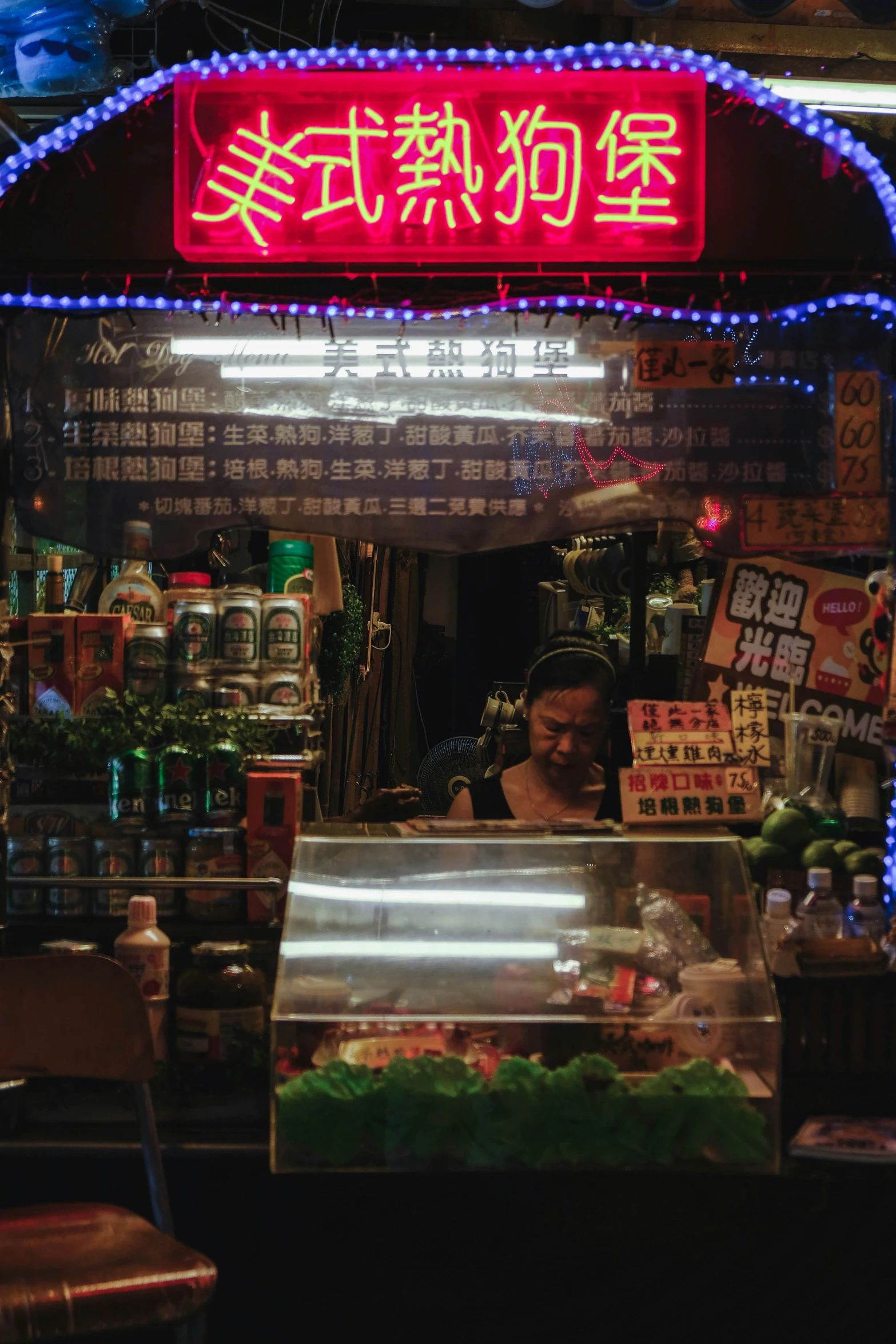 a woman looking through the counter at a restaurant