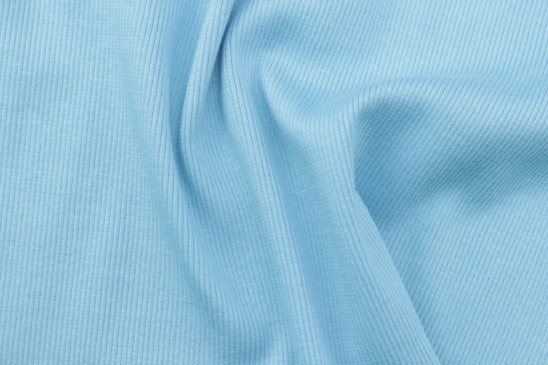 the fabric on a shirt is blue and has very light green color