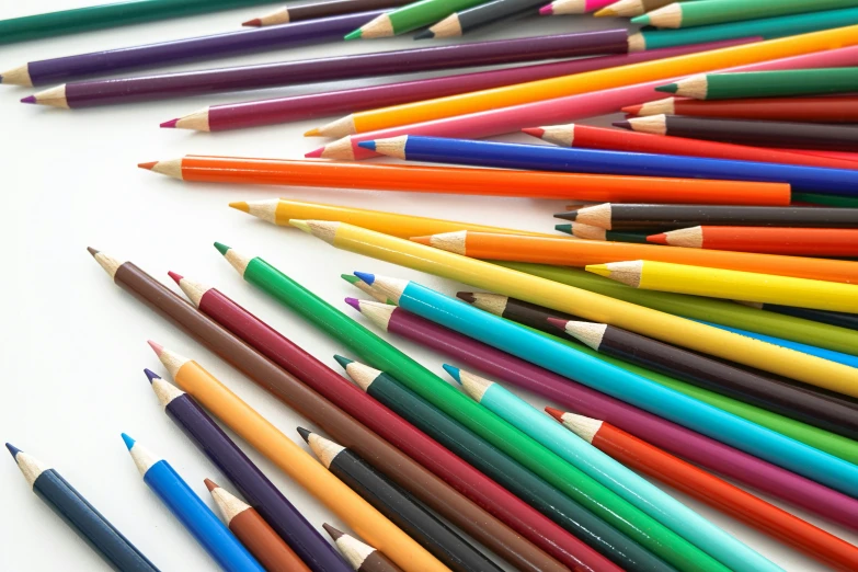 several rows of colorful pencils arranged in a row