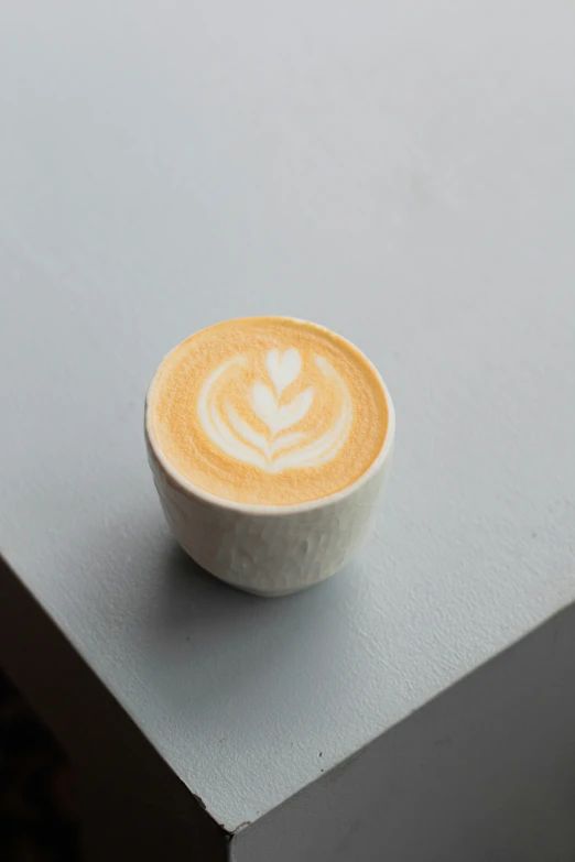 a small cup of coffee sitting on top of a counter