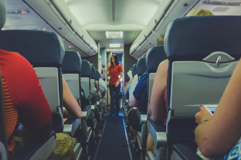 view of the inside of an airplane as people sit