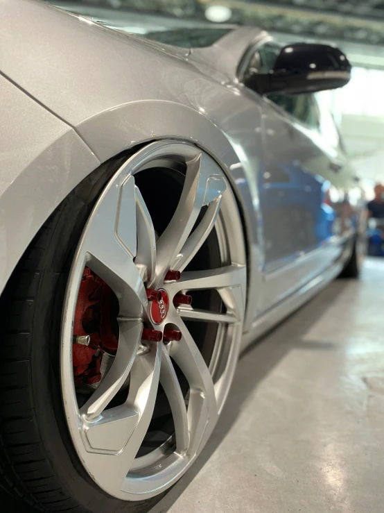 a sports car sits parked inside a showroom