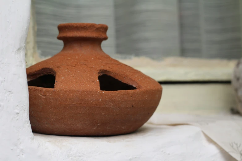 a large brown vase with a hole in it's center