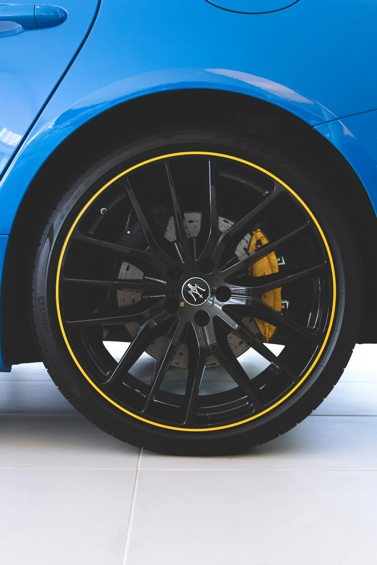 a blue car with yellow stripes on the tires