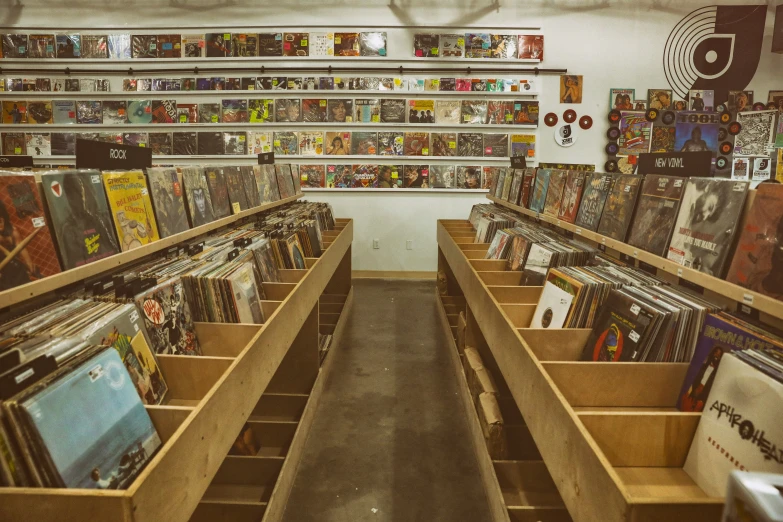 this is a collection of records and cassettes on shelves in a record shop