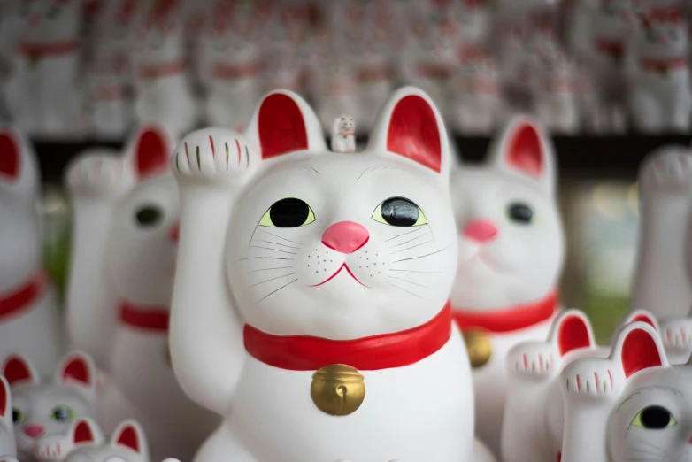 a group of white cat ornaments on display