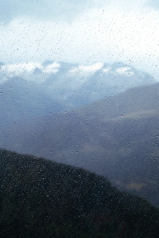 drops of water are coming down on a window