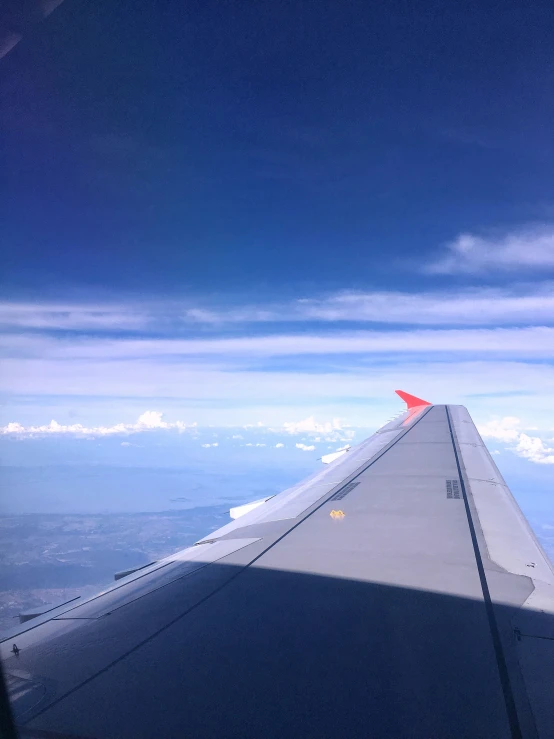 a plane wing seen from above in the sky