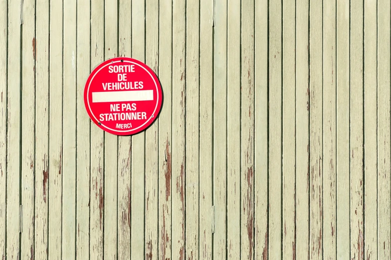 red and white street sign on wooden surface