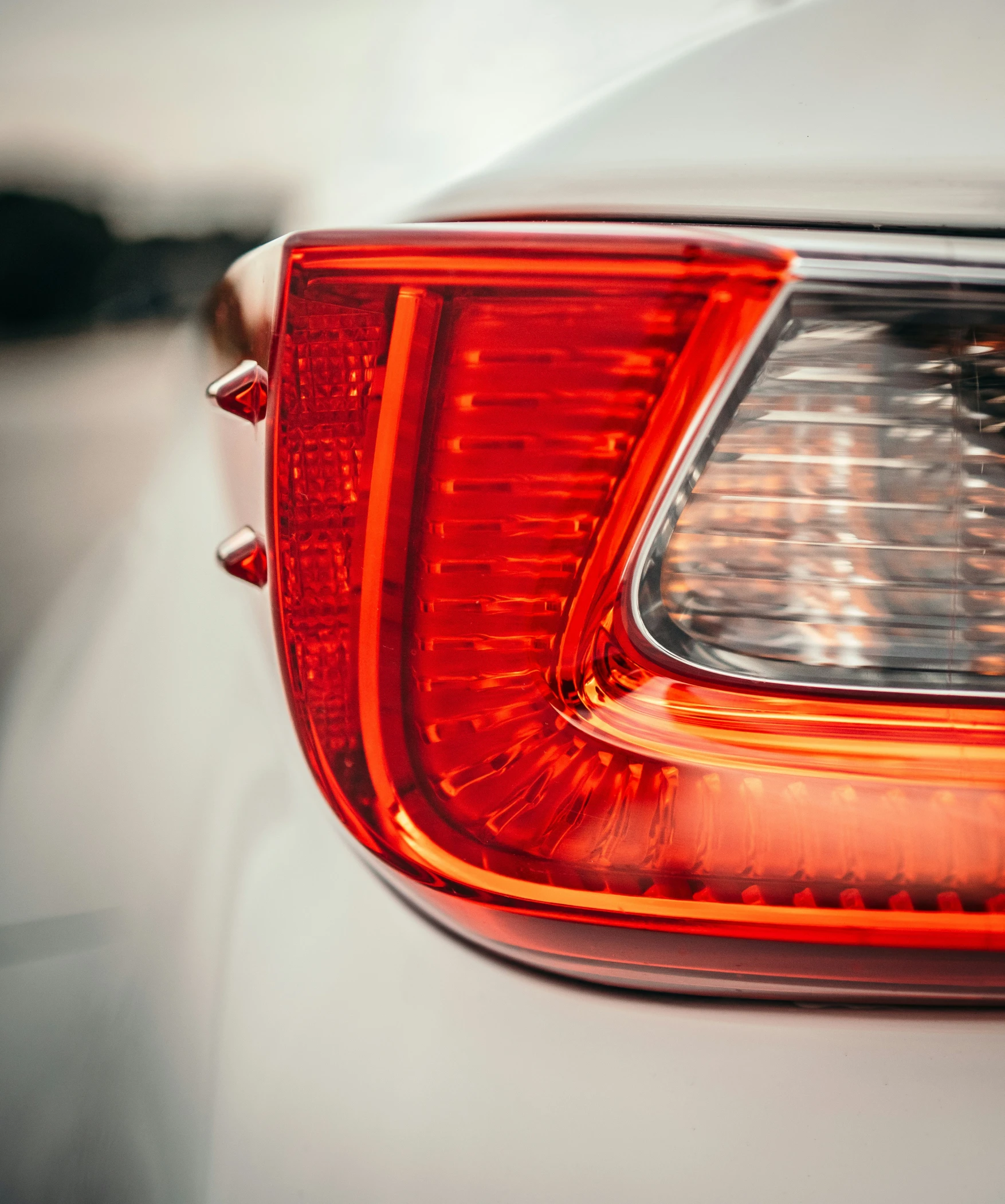 tail light of a white car with no visible head lights