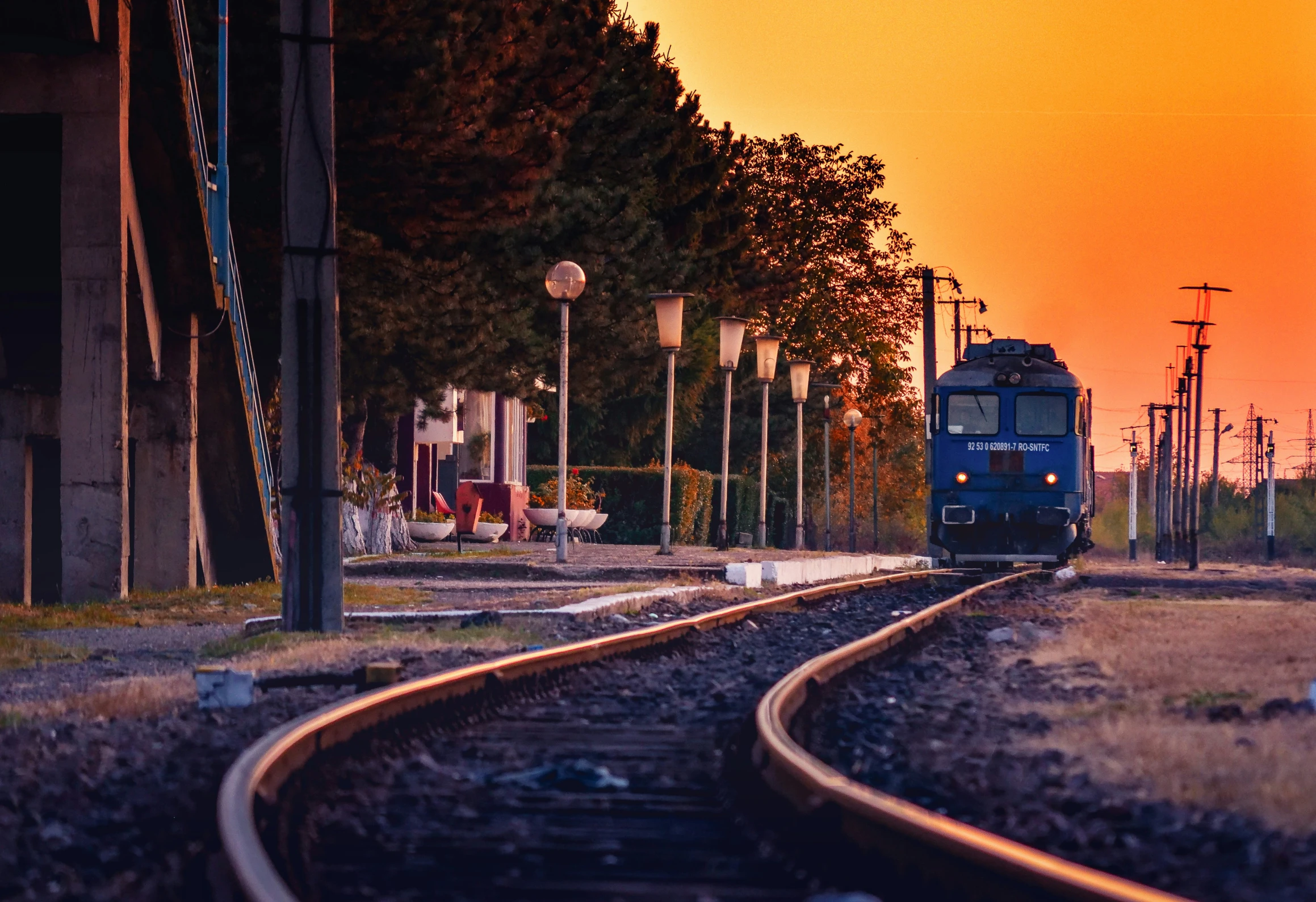 a train is approaching at the railroad track