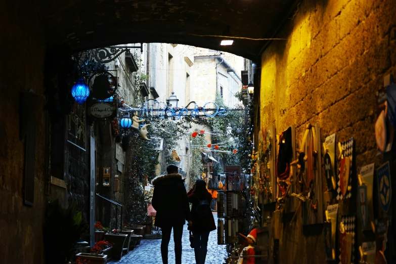 two people walk in an alley with no one around them