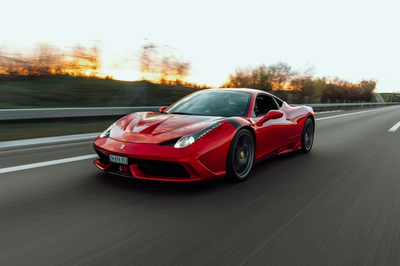 the ferrari sports car is speeding down the road