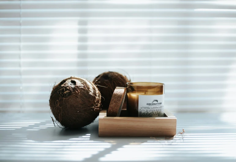 the coconut has been cut in half and placed on a stand with the other items