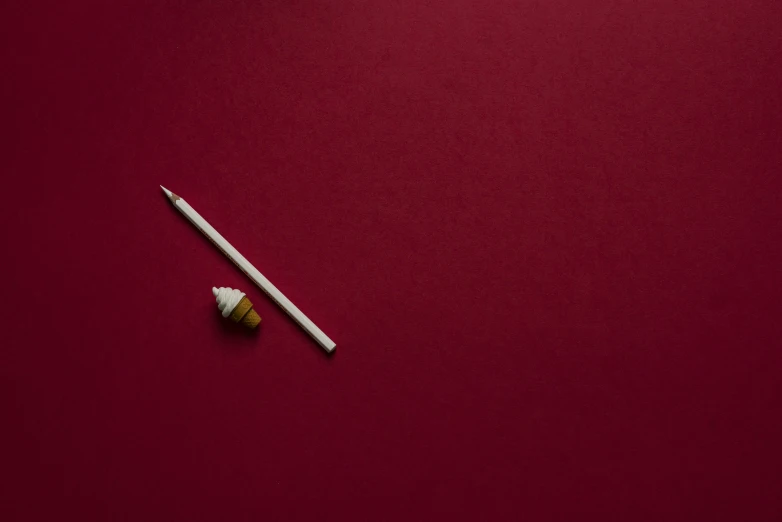 a red table that has two matchsticks next to it