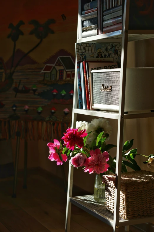 a room with two shelves and a large vase with flowers