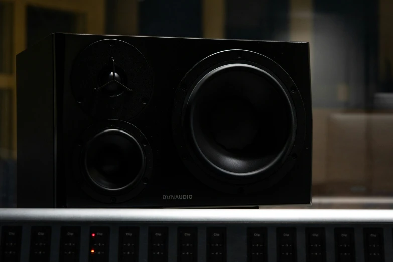 a black speaker with some s on the front of it
