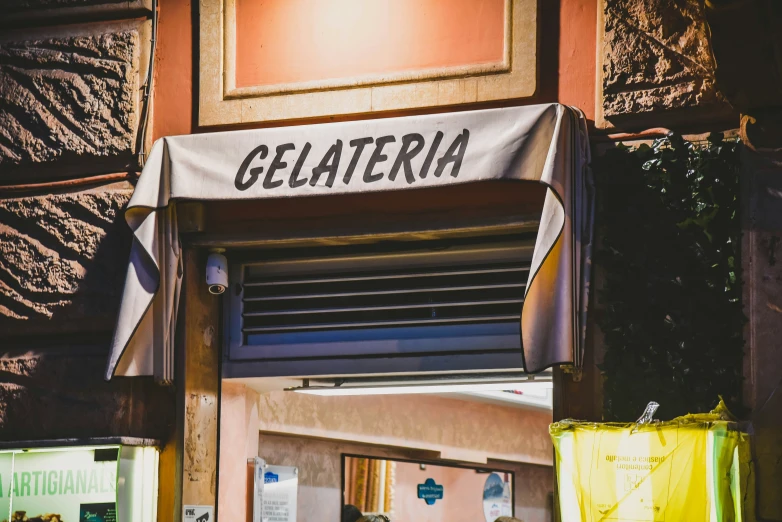 the sign for gelateria hanging on a wall