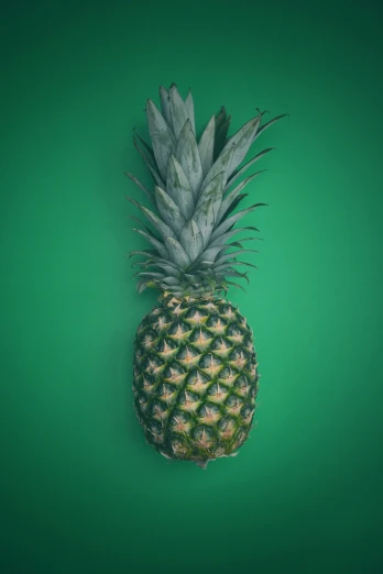 a pineapple that is cut in half on a green background