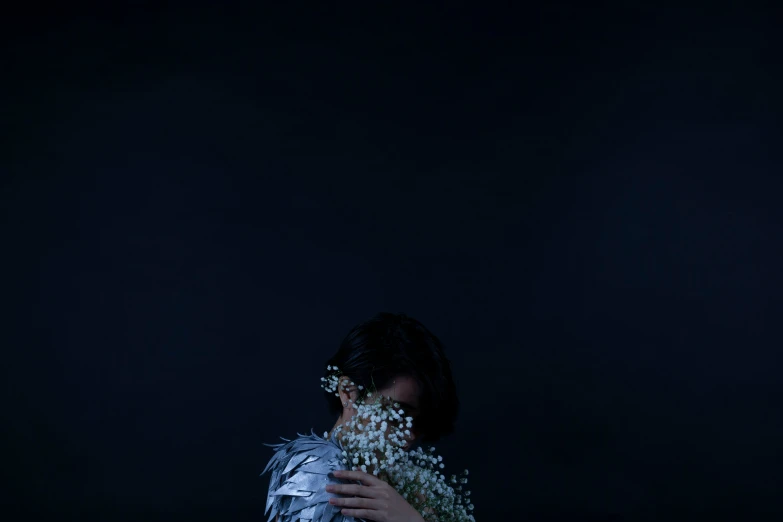 a woman wearing silver and sprinkled white flowers