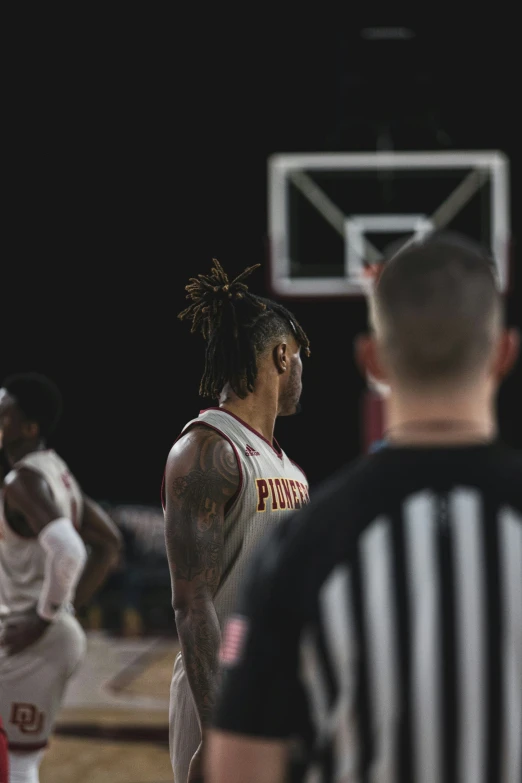 basketball players on a court playing basketball during a game