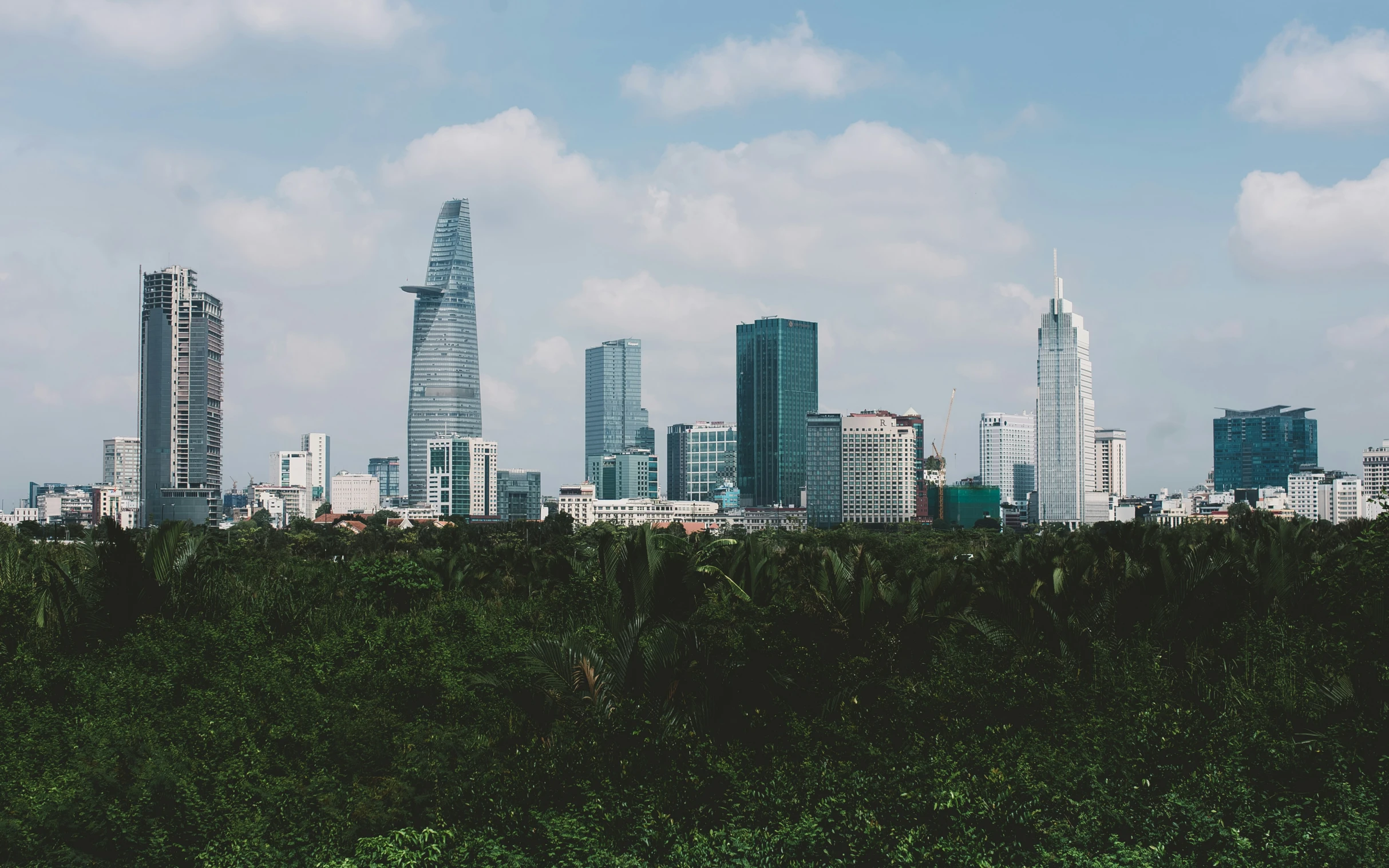 a city skyline with trees and buildings in the background