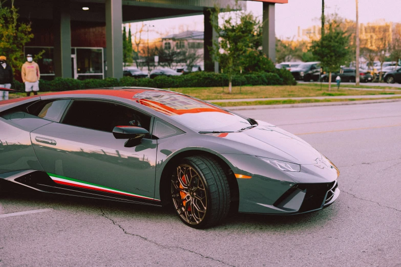 a silver sports car parked in front of a dealership